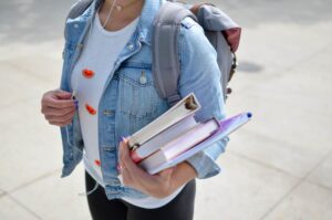 Back to school carrying books and rucksack copyright free Photo by Element5 on Unsplash